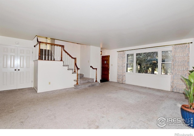 unfurnished living room featuring carpet floors