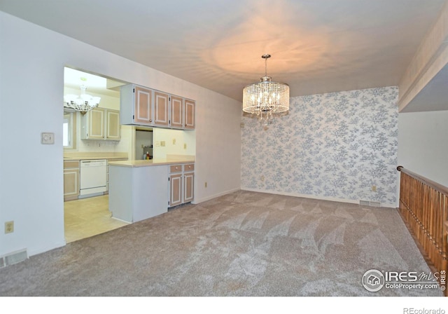 kitchen with white dishwasher, a notable chandelier, light carpet, and decorative light fixtures