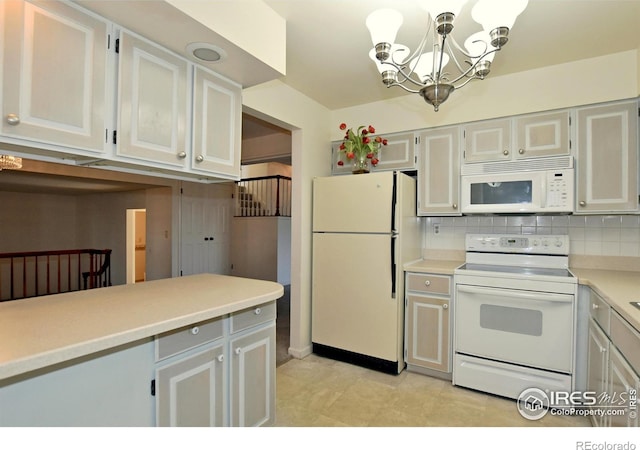 kitchen featuring tasteful backsplash, a chandelier, decorative light fixtures, white appliances, and light tile patterned floors