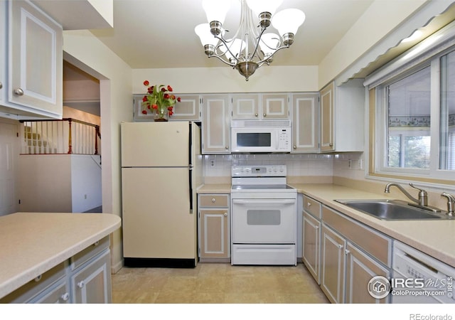 kitchen featuring sink, an inviting chandelier, tasteful backsplash, pendant lighting, and white appliances