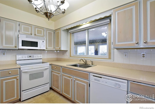 kitchen with decorative backsplash, sink, a chandelier, and white appliances