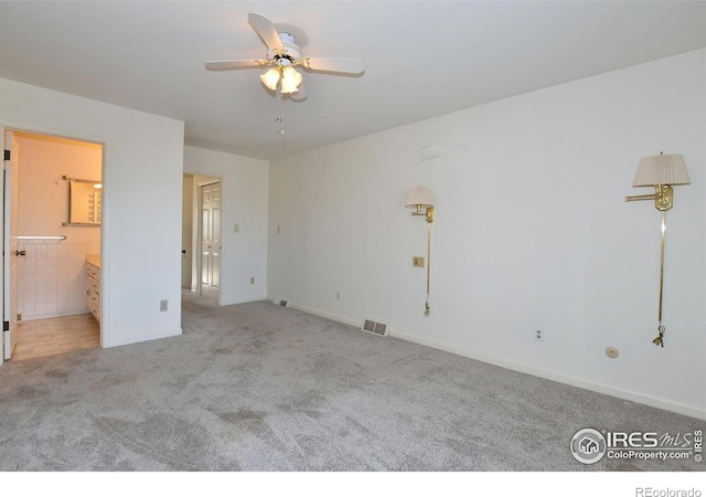 spare room featuring ceiling fan and light colored carpet