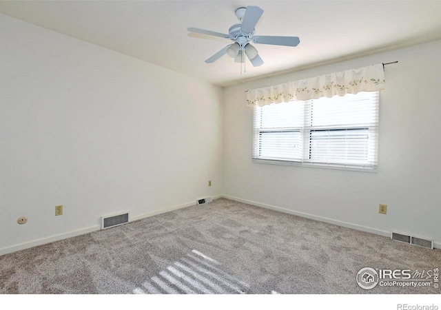 spare room with light carpet and ceiling fan