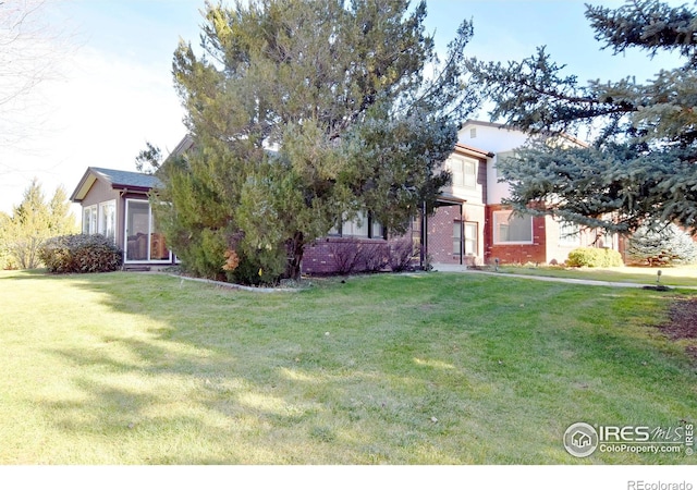 obstructed view of property featuring a front yard