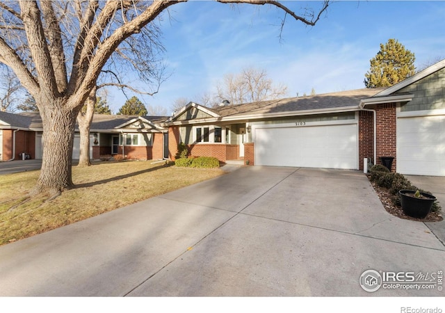 ranch-style home featuring a garage and a front yard