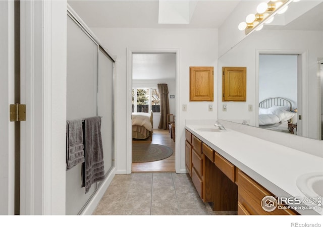 bathroom with vanity, tile patterned flooring, and a shower with shower door