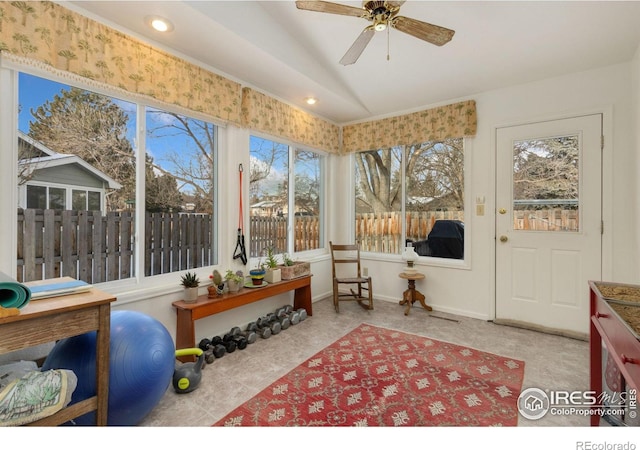 sunroom featuring vaulted ceiling and ceiling fan