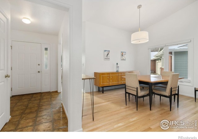 dining area featuring vaulted ceiling