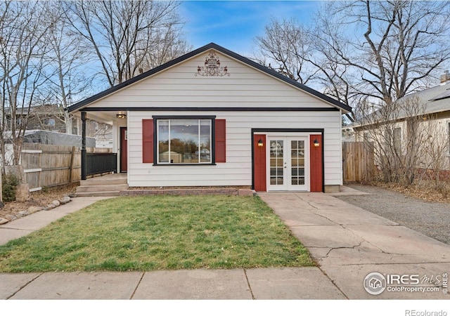 view of front of property with a front yard and french doors