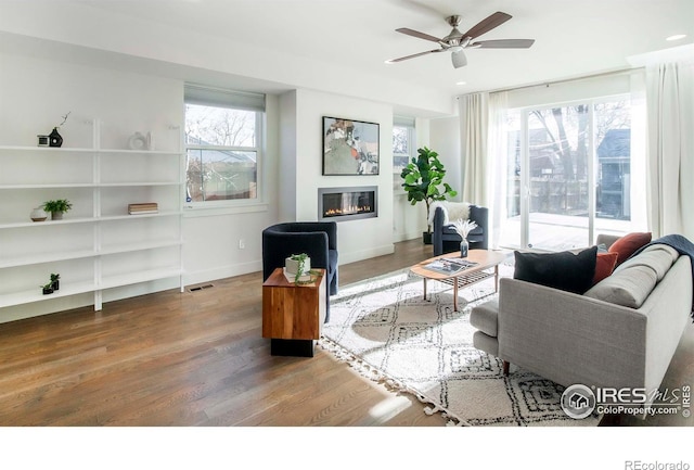 living room featuring hardwood / wood-style floors, plenty of natural light, and ceiling fan