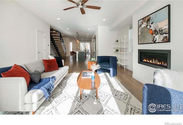 living room with ceiling fan and wood-type flooring