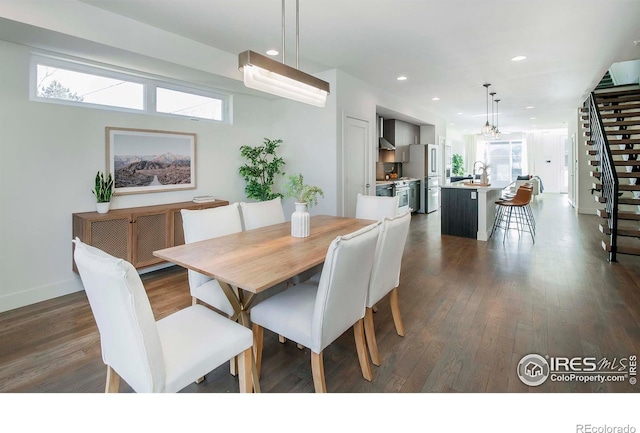 dining area featuring a wealth of natural light, dark hardwood / wood-style flooring, and sink