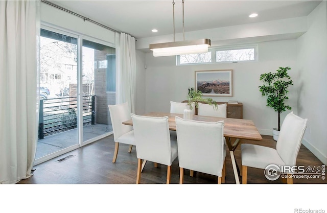 dining space featuring dark wood-type flooring