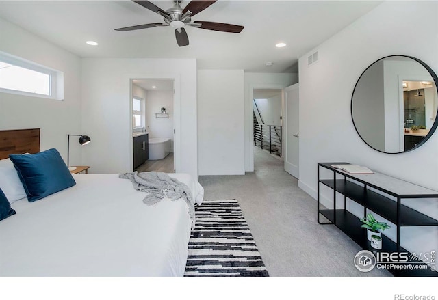 carpeted bedroom with ceiling fan and connected bathroom