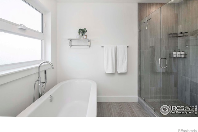 bathroom with shower with separate bathtub