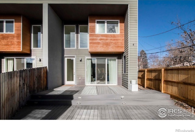 back of property featuring a wooden deck