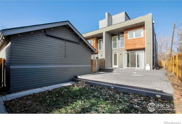 back of house with a wooden deck