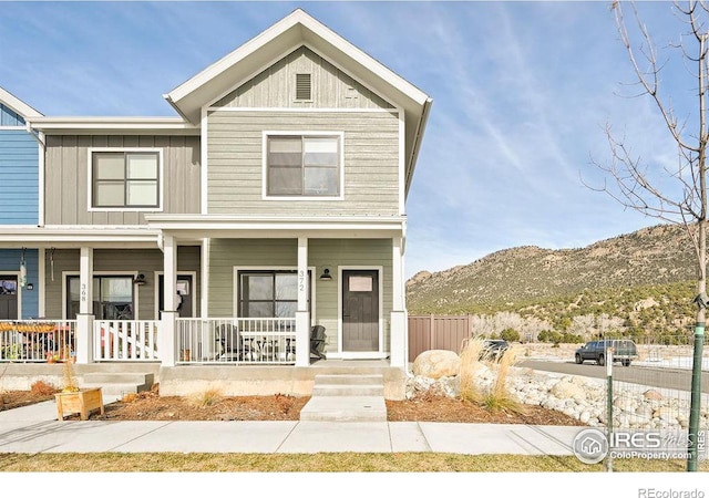 view of front of property with a mountain view and covered porch