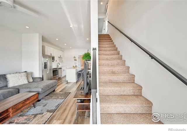 stairway with hardwood / wood-style flooring