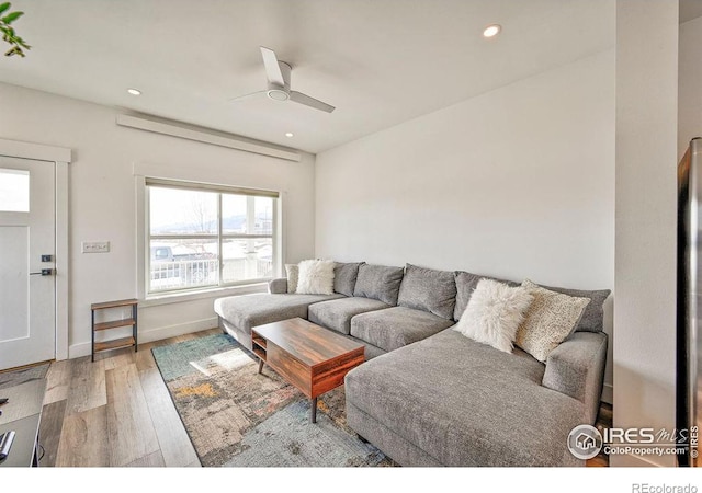 living room with hardwood / wood-style flooring and ceiling fan