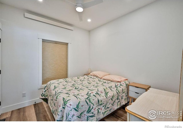 bedroom with ceiling fan and dark wood-type flooring