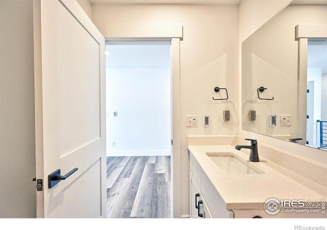 bathroom featuring vanity and hardwood / wood-style flooring