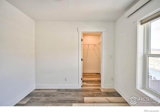 unfurnished room with hardwood / wood-style floors and a wealth of natural light