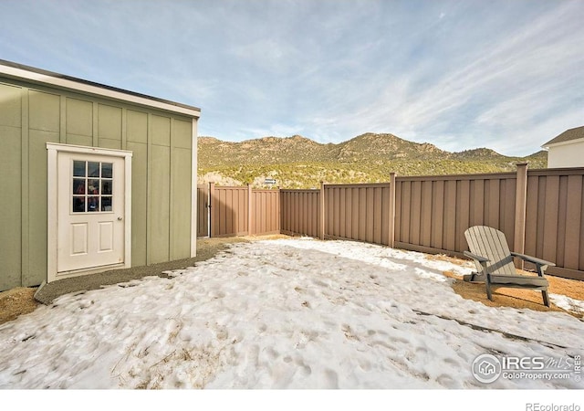 snowy yard with a mountain view