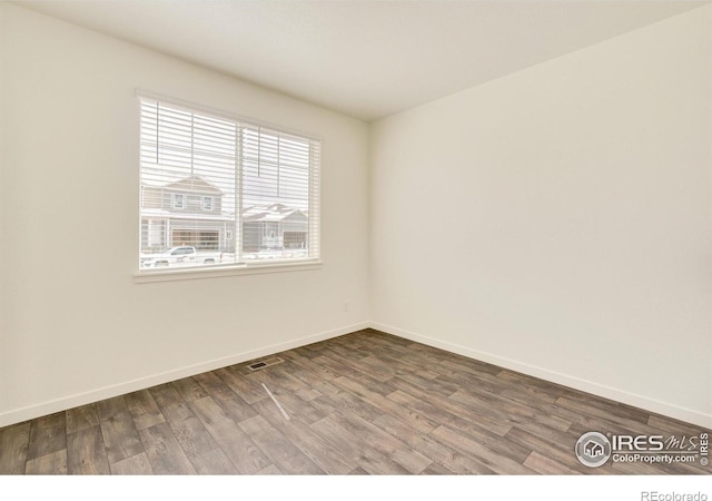 unfurnished room featuring hardwood / wood-style floors