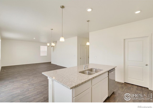 kitchen with sink, hanging light fixtures, dark wood-type flooring, stainless steel dishwasher, and a kitchen island with sink