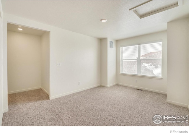 spare room featuring light colored carpet