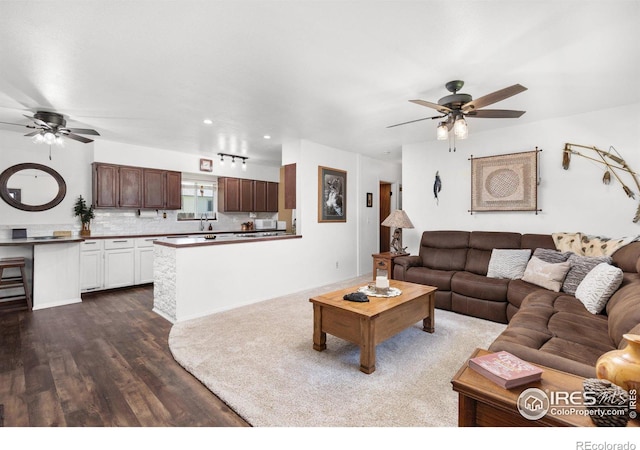 living room with hardwood / wood-style flooring and ceiling fan