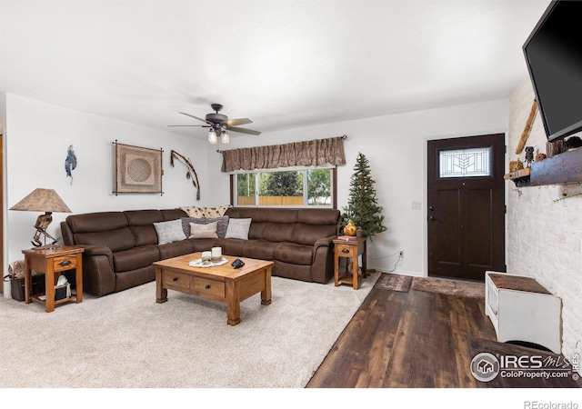 living room featuring hardwood / wood-style floors and ceiling fan