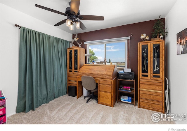 carpeted office featuring ceiling fan