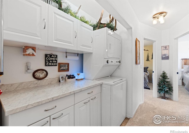 laundry room with stacked washer / dryer and light carpet