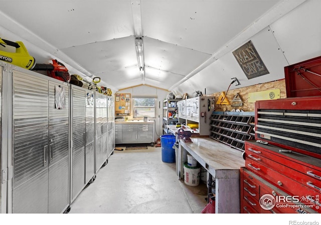 interior space featuring a workshop area and vaulted ceiling