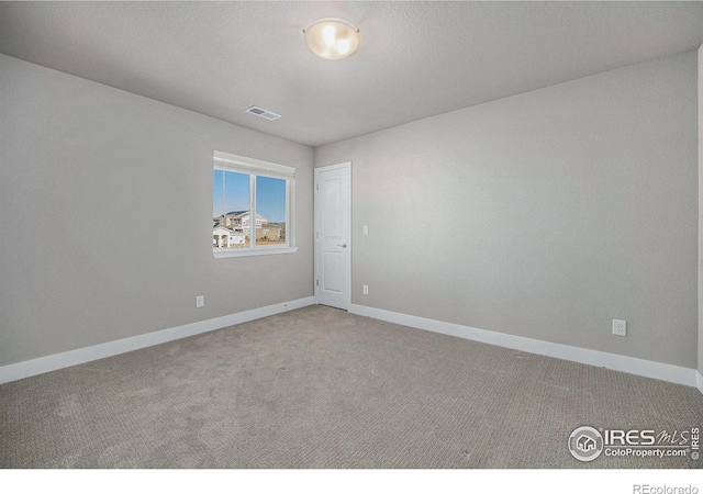 unfurnished room with carpet floors