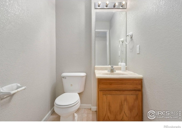 bathroom featuring toilet, vanity, and tile patterned floors