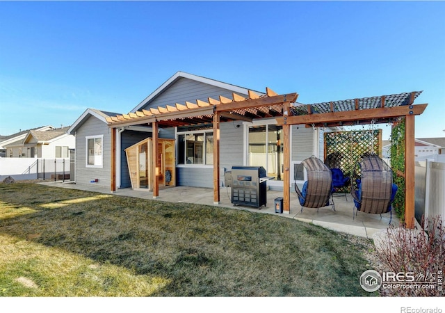 back of house featuring a patio, a pergola, and a lawn