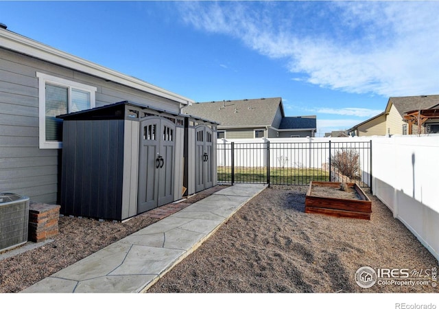 view of yard with central AC and a storage shed