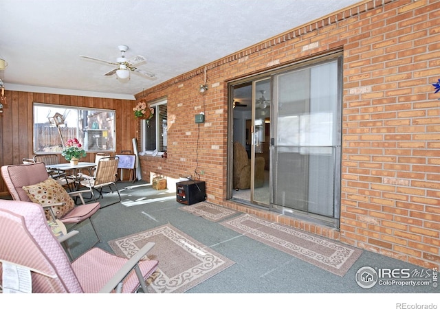 interior space with ceiling fan