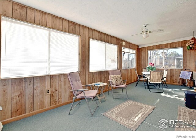 sunroom / solarium featuring ceiling fan