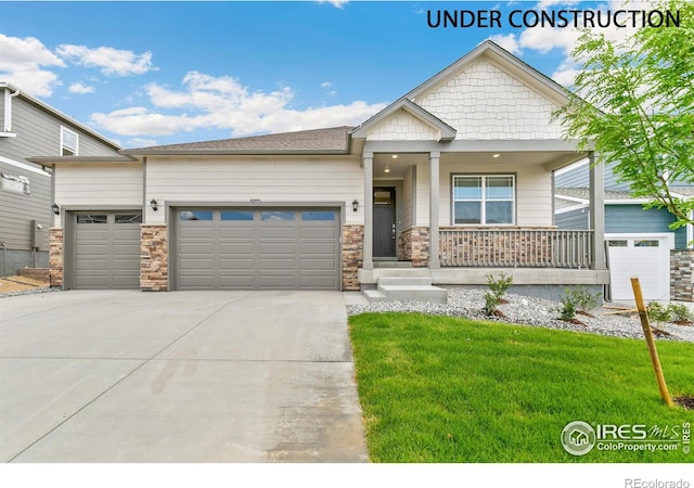 craftsman-style house with a porch, a garage, and a front lawn