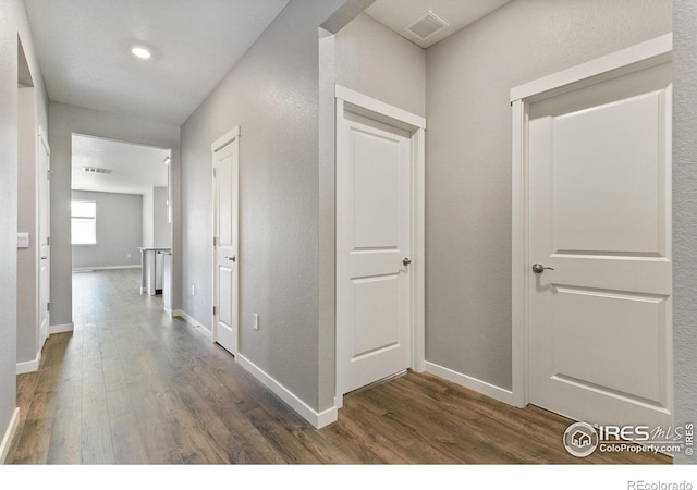 hall with dark hardwood / wood-style floors