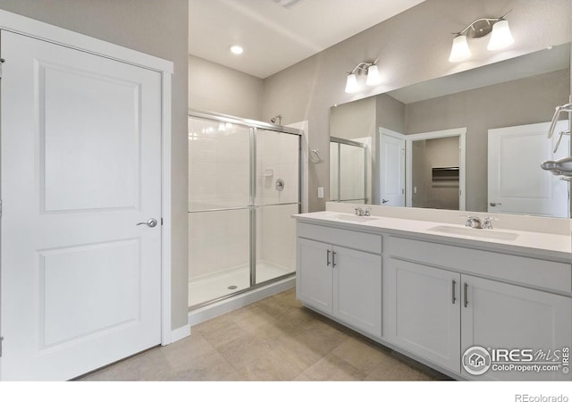 bathroom featuring vanity and a shower with shower door