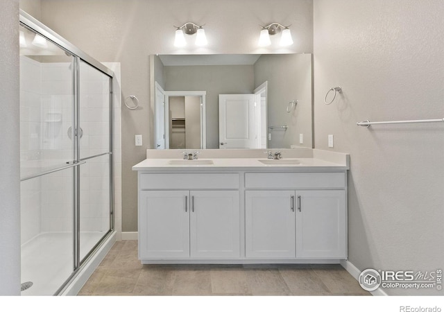 bathroom featuring vanity and a shower with shower door