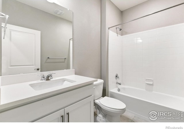 full bathroom featuring toilet, tile patterned floors, vanity, and bathing tub / shower combination