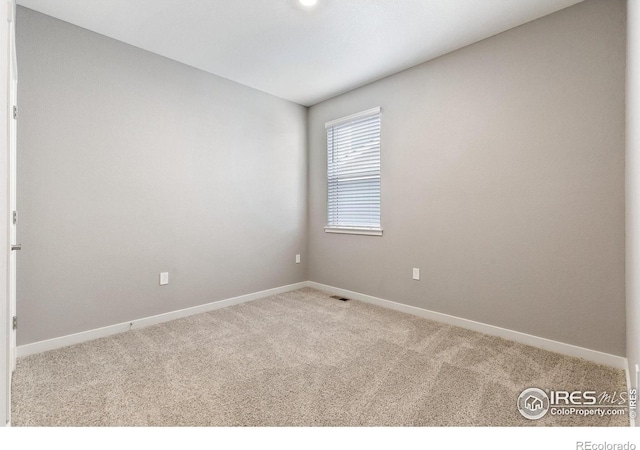 empty room with light colored carpet