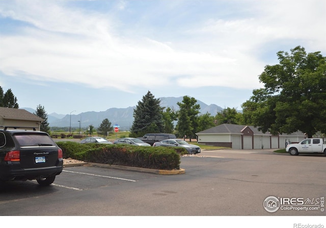 view of car parking with a mountain view