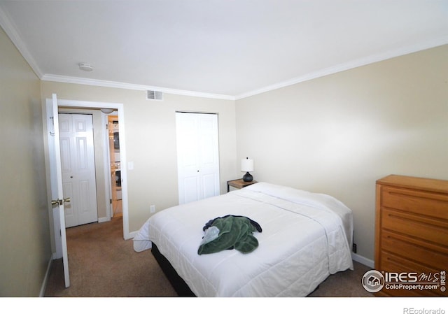 bedroom featuring crown molding, a closet, and dark carpet